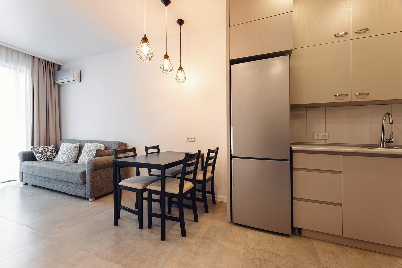 The living and dining area of a furnished apartment at NEXT Orange